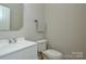 This home features a neutral powder room with white fixtures and modern finishes at 5707 Brandy Ridge Ln, Charlotte, NC 28269