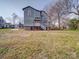 Back exterior view of home with porch, yard, and brick base at 613 S Mulberry St, Statesville, NC 28677