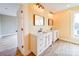 Charming bathroom with dual sinks featuring marble counters, decorative vanities, and modern lighting at 613 S Mulberry St, Statesville, NC 28677