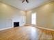 Spacious bedroom with a decorative fireplace, natural light, and hardwood flooring at 613 S Mulberry St, Statesville, NC 28677