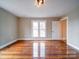 The bedroom has large windows that give plenty of natural light and hardwood floors at 613 S Mulberry St, Statesville, NC 28677