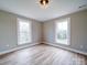 The bedroom has two windows that give plenty of natural light and neutral-colored walls at 613 S Mulberry St, Statesville, NC 28677