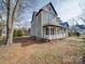 Angle view of a two-story home showcasing its architecture and surrounding landscape at 613 S Mulberry St, Statesville, NC 28677