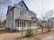 Angle view of a two-story home showcasing its architecture and surrounding landscape at 613 S Mulberry St, Statesville, NC 28677
