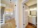 Hallway and staircase leads to an upstairs bathroom with a white vanity at 613 S Mulberry St, Statesville, NC 28677