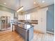 Modern kitchen with stainless steel appliances, a center island, white cabinetry, and decorative backsplash at 613 S Mulberry St, Statesville, NC 28677