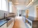 Bright and airy kitchen showcases an island with bar seating and stainless steel appliances with tile backsplash and sink at 613 S Mulberry St, Statesville, NC 28677