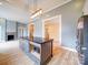 Open concept kitchen with center island, stainless steel appliances, decorative tile backsplash, and ample natural light at 613 S Mulberry St, Statesville, NC 28677