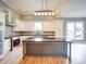 Modern kitchen features an island with seating, sleek countertops, and abundant cabinet space for storage and organization at 613 S Mulberry St, Statesville, NC 28677