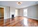 Bright living room features a decorative fireplace, hardwood floors, and neutral-colored walls at 613 S Mulberry St, Statesville, NC 28677