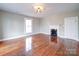 Bright living room showcases hardwood floors, a classic fireplace, and a window view at 613 S Mulberry St, Statesville, NC 28677
