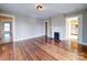 Living room featuring a decorative fireplace, hardwood floors, and neutral-colored walls at 613 S Mulberry St, Statesville, NC 28677