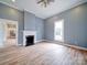Spacious living room features hardwood floors, a classic fireplace, and plenty of natural light from a window at 613 S Mulberry St, Statesville, NC 28677