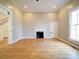 Well-lit living room featuring classic wood floors and a decorative fireplace with a white mantel at 613 S Mulberry St, Statesville, NC 28677