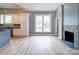 Open-concept room with fireplace, hardwood floors and great natural light, connects kitchen and staircase at 613 S Mulberry St, Statesville, NC 28677