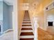 Staircase featuring wood stairs with white risers and banister at 613 S Mulberry St, Statesville, NC 28677