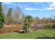 Tranquil lake view from the lush green backyard with a wooden dock at 7977 Lucky Creek Ln, Denver, NC 28037