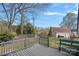 Spacious backyard deck with grey railing, providing scenic views of the wooded surroundings at 7977 Lucky Creek Ln, Denver, NC 28037