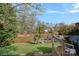Serene backyard featuring a lake view and direct water access from the deck at 7977 Lucky Creek Ln, Denver, NC 28037