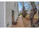 Exterior view of the home featuring a back door, walkway, and lush greenery at 7977 Lucky Creek Ln, Denver, NC 28037