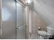 Bathroom with shower and toilet, featuring tile walls and floors and an angled ceiling at 7977 Lucky Creek Ln, Denver, NC 28037