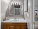 Bathroom featuring wood vanity, white countertop, mirror, and a glass-door shower at 7977 Lucky Creek Ln, Denver, NC 28037