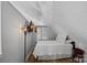 Bedroom featuring twin bed, hardwood floors, closet and mounted television at 7977 Lucky Creek Ln, Denver, NC 28037