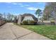 Unique home featuring a striking stone chimney and a long driveway leading to the property at 7977 Lucky Creek Ln, Denver, NC 28037