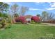 Charming home featuring a well-manicured lawn, flowering shrubs, and a quaint walkway to the entrance at 7977 Lucky Creek Ln, Denver, NC 28037