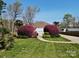 Charming home with a unique design and beautifully landscaped front yard featuring vibrant bushes at 7977 Lucky Creek Ln, Denver, NC 28037