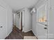 Hallway with a view through the front door, closet, artwork, and air conditioning unit at 7977 Lucky Creek Ln, Denver, NC 28037