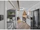 Open kitchen and laundry area with appliances, open shelving, and views to the dining area at 7977 Lucky Creek Ln, Denver, NC 28037