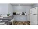 Small kitchenette area featuring a sink, countertop, microwave, and compact refrigerator at 7977 Lucky Creek Ln, Denver, NC 28037