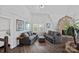 Cozy living room with stone fireplace, two gray sofas, ottoman and a window with natural light at 7977 Lucky Creek Ln, Denver, NC 28037