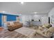 Cozy living room with a sofa, armchairs, kitchenette, breakfast bar, and hardwood floors at 7977 Lucky Creek Ln, Denver, NC 28037