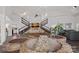 Large living room with a stone waterfall feature, staircase, and open floor plan at 7977 Lucky Creek Ln, Denver, NC 28037