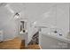 Bright and airy staircase leading to an open floor plan with wood floors and white walls at 7977 Lucky Creek Ln, Denver, NC 28037