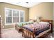 Cozy bedroom with two beds featuring colorful quilts and a bright window, creating a cheerful space at 1005 Antioch Woods Ln, Matthews, NC 28104