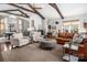 Spacious living room with vaulted ceiling, exposed beams, and cozy seating around a central ottoman at 1005 Antioch Woods Ln, Matthews, NC 28104