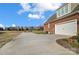 Long driveway leading to a two-car attached garage, with backyard at 1025 Coppergate Dr, Salisbury, NC 28147