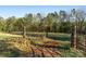 Open pasture with trees, wire fence, and gated entrance at 1035 Ride An Hour Way, Stanley, NC 28164