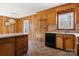 Kitchen with island, wood cabinets, and vinyl floor at 1053 Fye Dr, Newton, NC 28658