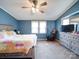 Inviting bedroom featuring a bed, dresser, ceiling fan, and a large window at 1075 Fye Dr, Newton, NC 28658