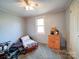 Cozy bedroom with a bed, dresser, and window, decorated with personal items at 1075 Fye Dr, Newton, NC 28658