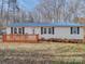 Charming home featuring a blue roof, new deck, and manicured landscaping at 1075 Fye Dr, Newton, NC 28658