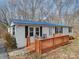 Single-story home with a blue metal roof and a wooden deck at 1075 Fye Dr, Newton, NC 28658