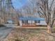 Charming home featuring a blue roof, new deck, and manicured landscaping at 1075 Fye Dr, Newton, NC 28658
