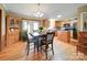 Eat-in kitchen and dining room with wood cabinets, stainless steel appliances, hardwood floors, and natural light from windows at 1075 Fye Dr, Newton, NC 28658