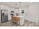 Modern white kitchen with stainless steel appliances, a center island, and stylish bar stools at 1116 Thayer Glen Ct, Charlotte, NC 28213