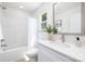 Bright bathroom featuring a tub with shower, vanity with white counter and a decorative mirror at 1124 Thayer Glen Ct, Charlotte, NC 28213